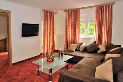 a living room with a couch and a table at Hotel Medno in Ljubljana
