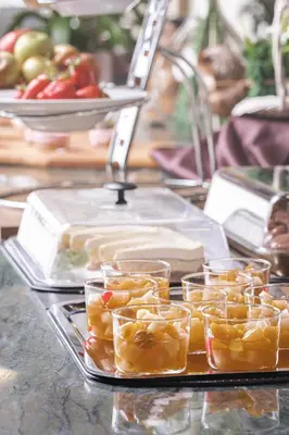 a tray of food with fruit on a table at Grand Hotel BELLEVUE in Pohorje