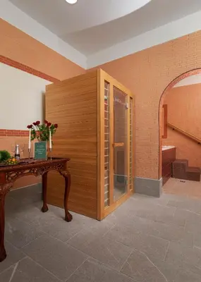 a room with a wooden wall and a wooden table at Grand Hotel BELLEVUE in Pohorje