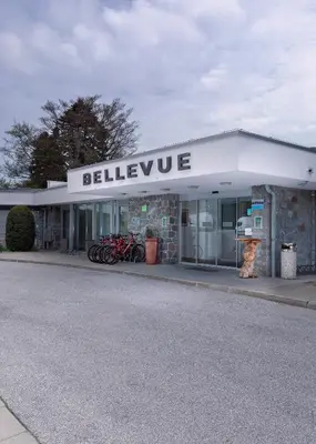 a building with bikes parked in front of it at Grand Hotel BELLEVUE in Pohorje