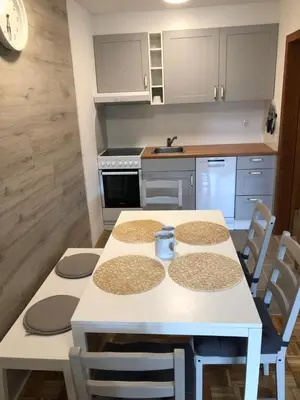 a kitchen with a white table and chairs at Apartma Vintage Bohinj in Bohinj