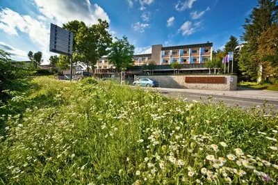 a field of flowers in front of a building at Hotel Astoria Superior in Bled