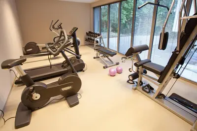 a gym with treadmills and exercise equipment in a room at Hotel Astoria Superior in Bled