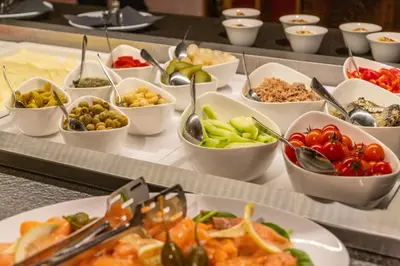 a buffet with many bowls of different types of food at Hotel Sport - Terme Krka in Otočec