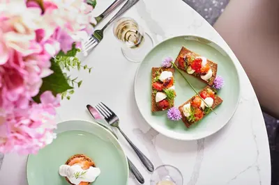 two plates of food on a table with flowers at Hotel Sport - Terme Krka in Otočec