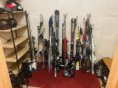 a bunch of skis are hanging on a wall at Hotel Pohorje in Maribor