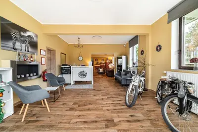 a living room with two motorcycles parked in it at Hotel Pohorje in Maribor
