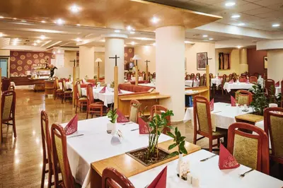 a dining room with white tables and chairs at Terme Zrece - Hotel Vital in Zreče