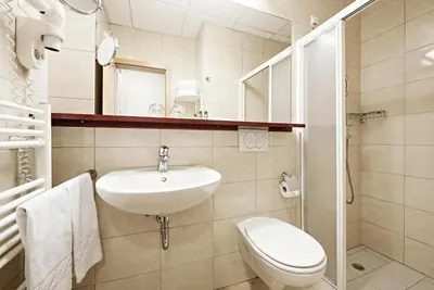 a white bathroom with a sink and a toilet at Hotel Radin, Radenci Spa Resort - Sava Hotels & Resorts in Radenci