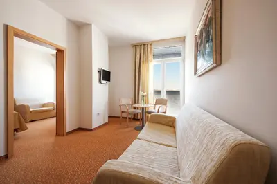 a living room with a couch and a table at Hotel Radin, Radenci Spa Resort - Sava Hotels & Resorts in Radenci