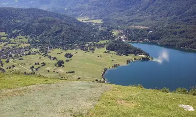 an aerial view of a lake in the mountains at Brunarica na Goreljeku, Pokljuka in Bohinj