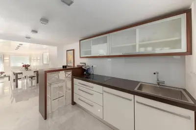 a kitchen with white cabinets and a sink at Deluxe Apartma Jana in Ljubljana