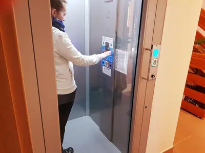 a woman is standing in front of a refrigerator at Hotel Gasperin Bohinj in Bohinj
