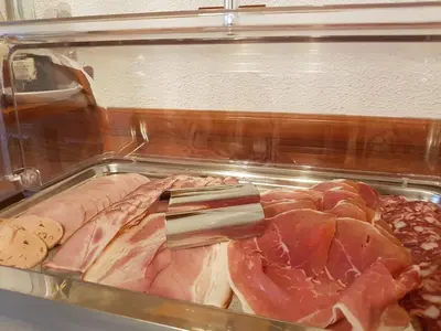 a close up of meat and other food items at Hotel Gasperin Bohinj in Bohinj