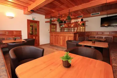 a dining room with wooden tables and chairs at Hotel Gasperin Bohinj in Bohinj