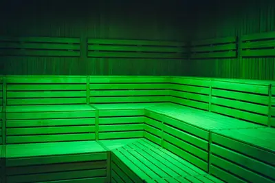 an empty room with green shelves and tables at Pohorje Village Wellbeing Resort - Wellness & Spa Hotel Bolfenk in Pohorje
