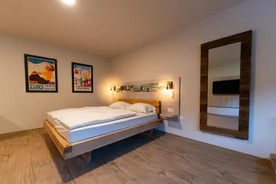 a bedroom with a bed and a mirror at Hotel Arena Maribor in Maribor