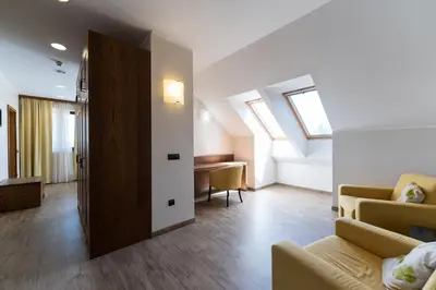 a living room with skylights and a couch and a table at Hotel Arena Maribor in Maribor