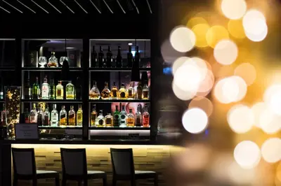 a bar with several bottles of alcohol at Postojna Cave Hotel Jama in Postojna