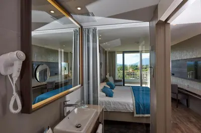 a hotel room with a bed and a mirror at Postojna Cave Hotel Jama in Postojna
