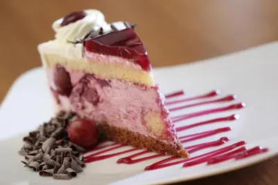a piece of cake on a plate with a fork at Hotel Evropa in Celje