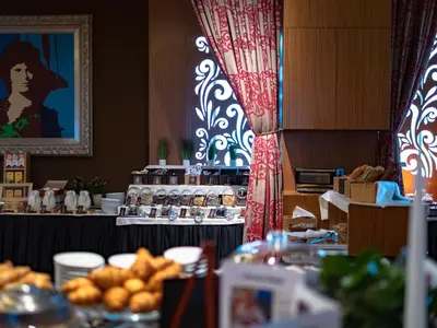 a table with food on it in a restaurant at Hotel Evropa in Celje