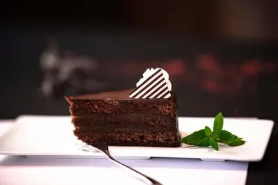 a piece of chocolate cake on a white plate at Hotel Evropa in Celje