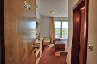 a corridor of a hotel room with a view of a room at Hotel Krek Superior in Lesce