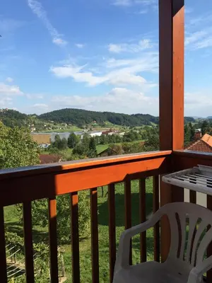 a balcony with a table and a chair and a view at Garni Hotel Zvon in Zreče