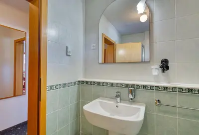a bathroom with a sink and a mirror at Garni Hotel Zvon in Zreče