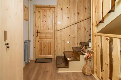 a hallway of a log cabin with wooden walls at Pension Cerkovnik in Bohinj
