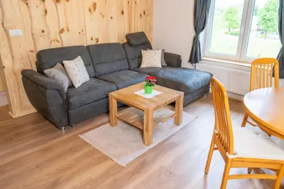 a living room with a couch and a table at Pension Cerkovnik in Bohinj