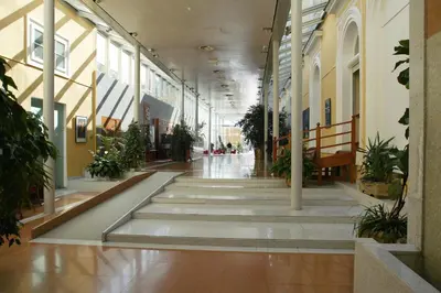 an empty hallway with potted plants in a building at Grand Hotel Rogaska in Rogaška Slatina