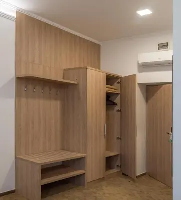 a closet with wooden cabinets in a room at Grand Hotel Rogaska in Rogaška Slatina