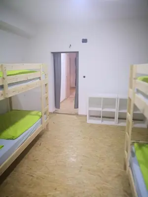 a room with three bunk beds and a hallway at Bus Station Beds in Bled