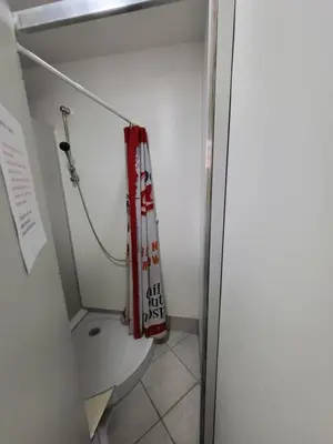 a small bathroom with a toilet in a room at Bus Station Beds in Bled