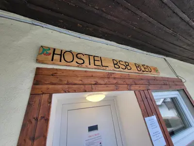 a sign over the door of a hostel best bed at Bus Station Beds in Bled