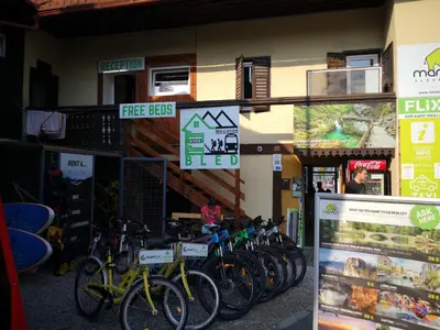 a bunch of bikes parked in front of a building at Bus Station Beds in Bled