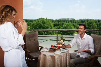a man and a woman sitting at a table at Hotel Livada Prestige - Terme 3000 - Sava Hotels & Resorts in Moravske Toplice