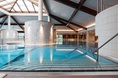 a large swimming pool in a building at Hotel Livada Prestige - Terme 3000 - Sava Hotels & Resorts in Moravske Toplice