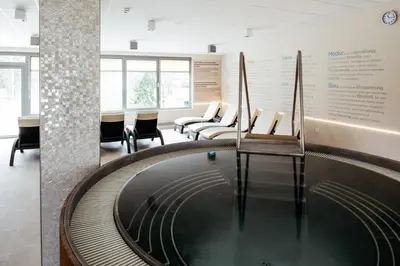 a large pool in a waiting room with chairs at Hotel Termal - Terme 3000 - Sava Hotels & Resorts in Moravske Toplice