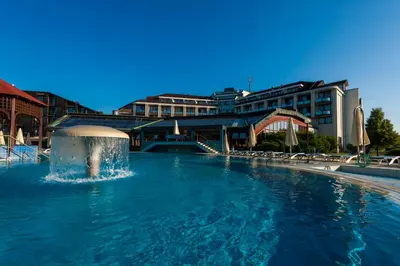 a pool with a fountain in front of a building at Hotel Ajda - Terme 3000 - Sava Hotels & Resorts in Moravske Toplice