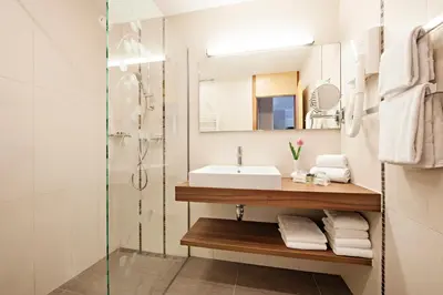 a bathroom with a sink and a shower at Hotel Ajda - Terme 3000 - Sava Hotels & Resorts in Moravske Toplice