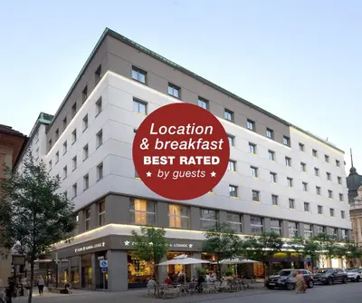 a large building with a sign for a hotel at Best Western Premier Hotel Slon in Ljubljana