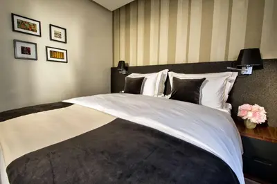 a bedroom with a large bed with white sheets and pillows at Best Western Premier Hotel Slon in Ljubljana