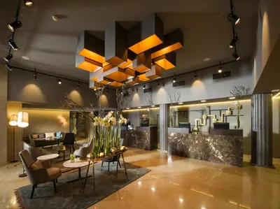a lobby of a hotel with a table and chairs at Best Western Premier Hotel Slon in Ljubljana