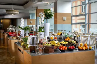 a buffet with fruits and vegetables on a counter at Best Western Premier Hotel Slon in Ljubljana