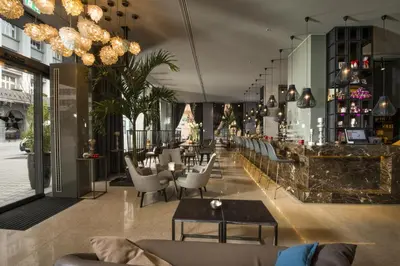 a restaurant with chairs and tables and a bar at Best Western Premier Hotel Slon in Ljubljana