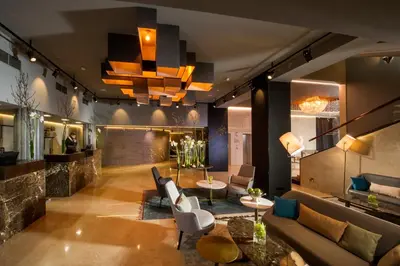 a lobby with a couch and chairs and a table at Best Western Premier Hotel Slon in Ljubljana