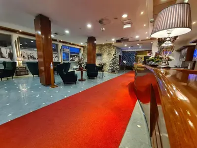 a red carpet in the lobby of a hotel at Ramada Resort Kranjska Gora in Kranjska Gora